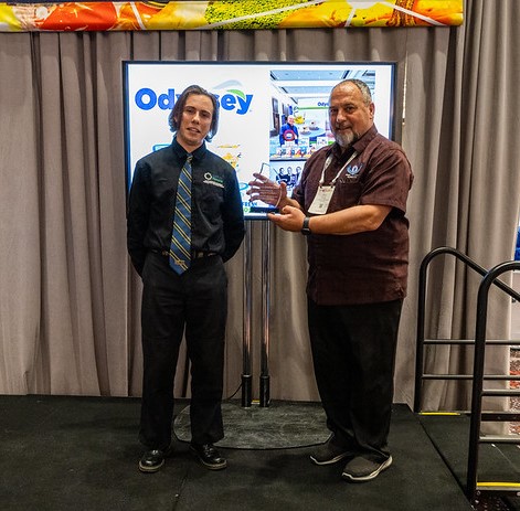two young men at the conference holding an award