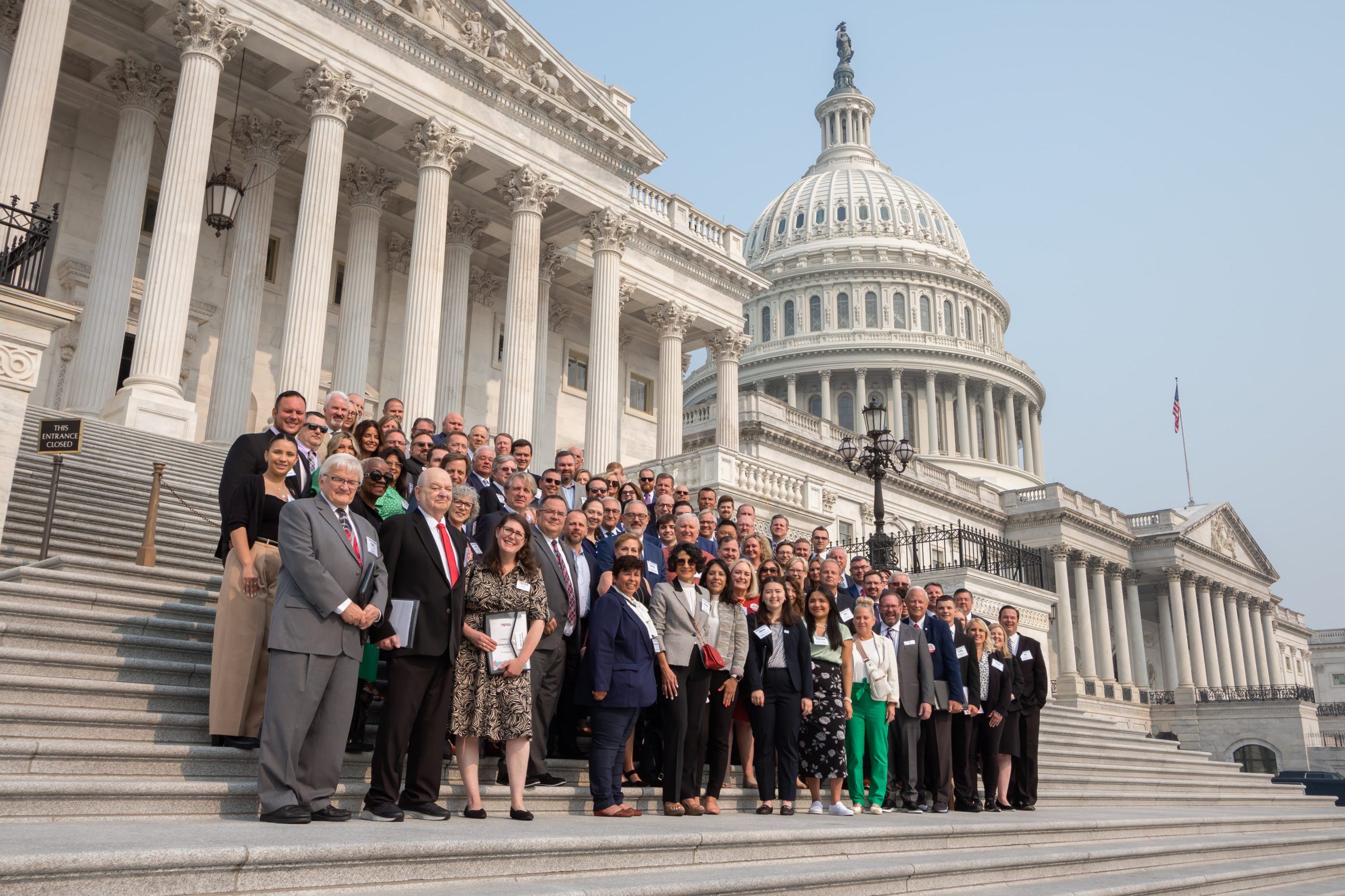 Large group posing on the U.S. Capitol steps.
