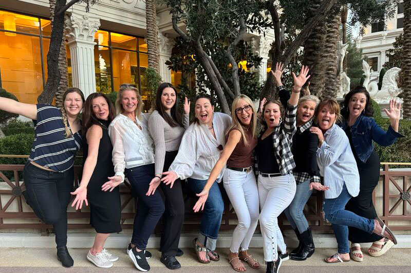 group of women smiling at conference