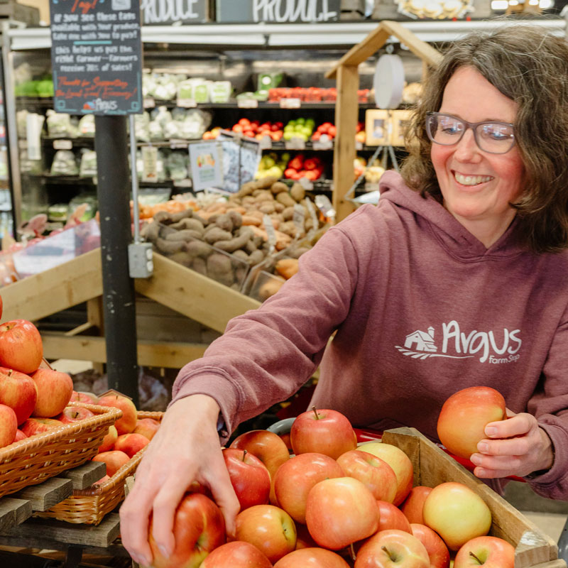 woman with apples at farm stop